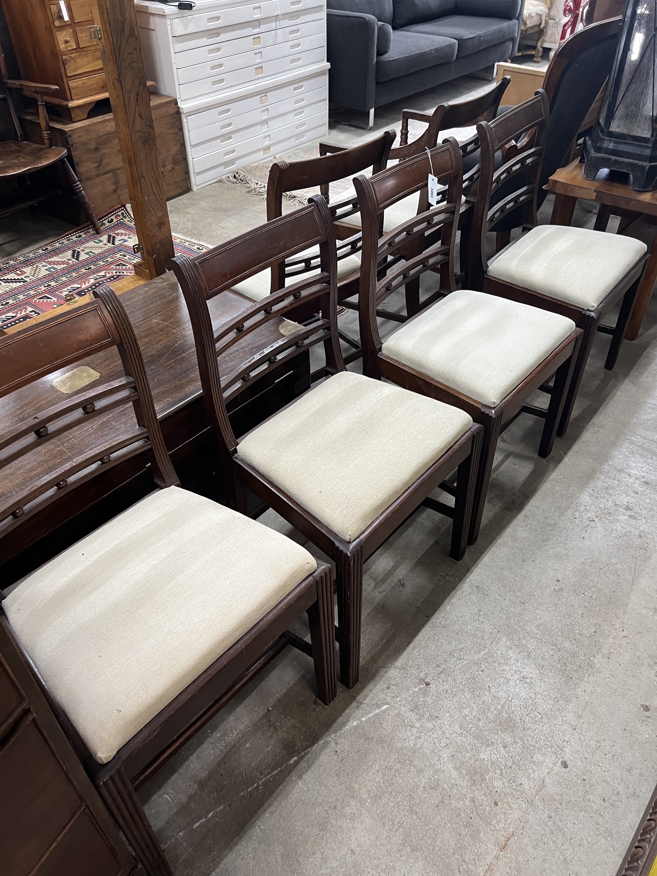 A set of six George III provincial mahogany dining chairs, one with arms